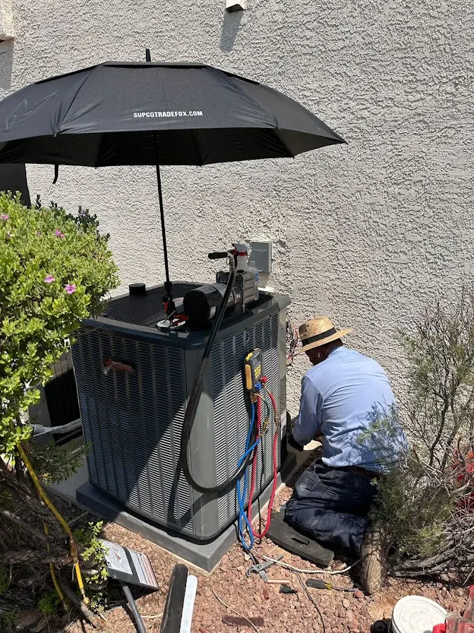 HVAC technician performing outdoor AC maintenance in Godley